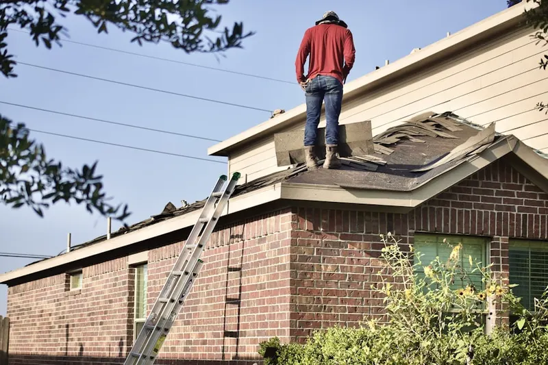 Professional roofer working on a residential roof in Pacific Ridge